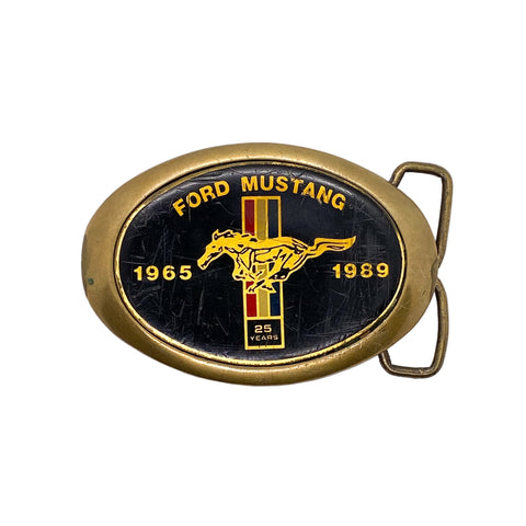 Ford Mustang belt buckle celebrating 25 years with a horse logo on a white background
