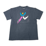 A faded black short-sleeve t-shirt with a colorful graphic on the front depicting stylized human figures in blue, pink, white, and yellow, laid flat on a white background.