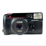 A vintage Pentax R-Zoom film camera in black with red accents, photographed against a light gray background.