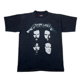 Black t-shirt with graphic design of four faces on a white background