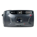 A Minolta Freedom AF 35mm film camera in dark gray, photographed from the front against a light gray background.