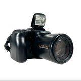 Black Olympus camera with lens and flash on a white background