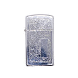 A silver metal lighter with an engraved floral pattern, shown on a textured white background.