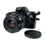 Canon EOS Rebel X camera with lens cap on a white background