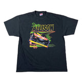 A black short-sleeve graphic T-shirt laid flat on a white background, featuring a colorful 'Desert Allison' racing design with a race car and neon-style lettering.