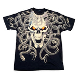 A black short-sleeve graphic T-shirt laid flat on a white surface, featuring a large skull and snake design with glowing orange eyes.