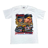 A white short-sleeve graphic T-shirt laid flat on a light gray background. The shirt features a large front print with portraits of Dale Earnhardt, the number 3 race car, and text reading 'Intimidator' and 'Legendary Champion.