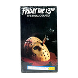 A boxed VHS or DVD release of the movie 'Friday the 13th: The Final Chapter' on a plain light gray studio background. The package is wrapped in clear plastic and shows the title in white at the top, a hockey mask with a nail through it and red blood effects in the center, and a small yellow sticker near the bottom.