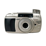 Silver Minolta camera with 'ELITE' and 'Supreme' branding on a white background