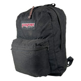 A black JanSport backpack with a front zippered pocket and the brand's logo patch on the front, photographed against a light gray studio background.