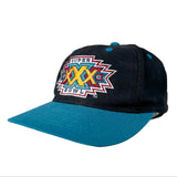 A vintage-style baseball cap featuring a dark navy blue crown with a colorful embroidered Super Bowl XXX logo on the front, and a bright teal curved brim.
