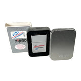 A silver Zippo lighter with 'The Heart of America' logo, shown with its black tin case and a white Chevrolet-branded box on a light gray background.