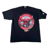 A black short-sleeve Chicago Bulls 1996 NBA Champions graphic t-shirt laid flat on a white background. The front features a large circular red, white, and gray graphic of the Chicago Bulls logo with 'CHICAGO BULLS 1996 NBA CHAMPIONS' text.