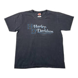 A faded black short-sleeve t-shirt with a distressed blue and white Harley-Davidson logo printed on the chest, laid flat against a white background.