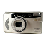 A silver Nikon OneTouch Zoom 90 AF Quartz DLR compact camera photographed from the front on a light gray background.
