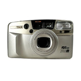 A silver Pentax 10Z Zoom 140m compact camera with a black top panel, shown on a light gray background.