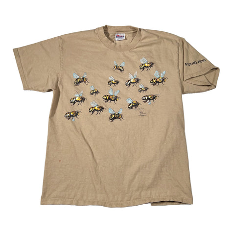 Beige t-shirt with bee designs on a white background