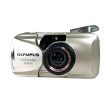 Silver Olympus camera on a white background
