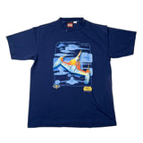 A navy blue Star Wars T-shirt laid flat on a light background, featuring a large graphic of the TIE fighter with blue, orange, and yellow details, and the Star Wars logo printed below.