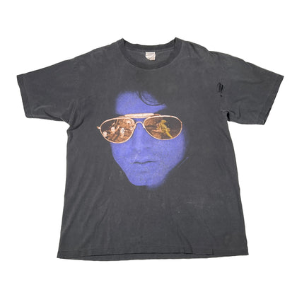 faded black t-shirt with a graphic of a face wearing sunglasses on a white background