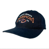 A navy blue baseball cap with 'WORLD SERIES CHAMPIONS 2001' embroidered on the front, featuring a purple and orange logo. The cap is photographed on a light gray studio background.