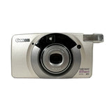 A Canon Sure Shot Zoom S digital camera in silver and black, photographed from the front against a light gray background.