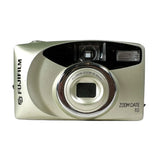 A silver and black Fujifilm ZOOM Date 60 compact camera photographed from the front on a light gray background.