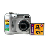 A silver Nikon digital camera with stickers on the side next to a Lexar Memory 128MB SD card, set against a plain light gray background.
