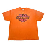 An orange short-sleeve t-shirt with a vintage-style Harley-Davidson logo printed on the chest, laid flat against a white background.