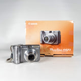 Canon PowerShot A620 digital camera with its packaging on a white background