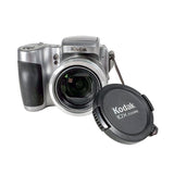 Kodak digital camera with lens cap on a white background
