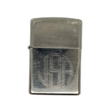 Silver zippo lighter with 'USA' engraving on a white textured background