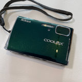 Nikon Coolpix digital camera on a light gray background