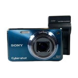 Sony Cyber-shot digital camera with battery charger on a white background