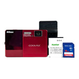 Red Nikon Coolpix camera with packaging and SanDisk SD card on a white background