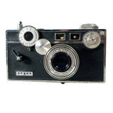 An Argus SLR film camera with a black textured leather body and silver metal dials and lens, photographed on a white background.