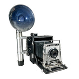 Vintage camera with large lens on a white background