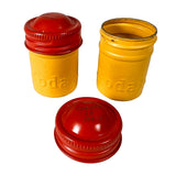 Two yellow containers with red lids on a white background