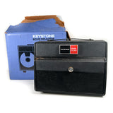 Keystone movie projector with packaging on a white background