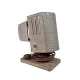Vintage-style lamp with textured shade and brown cord on a white background