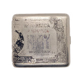 A vintage silver-colored metal bill collector or money clip shaped like a U.S.