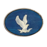 Decorative brooch with a white eagle on a blue background