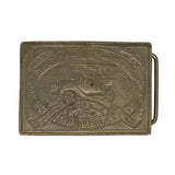 Bronze belt buckle with vintage car design on a white background