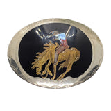 Belt buckle with gold horse and rider design on a black background