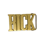 Gold belt buckle with 'RICK' engraved on a white background