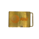 Brass belt buckle with AT&T logo on a white background