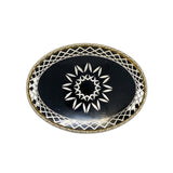 Decorative plate with black center and white star pattern, gold rim on a white background