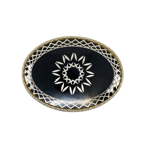Decorative plate with black center and white star pattern, gold rim on a white background