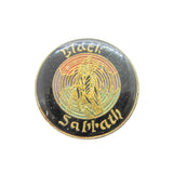 Round badge with 'Black Sabbath' logo on a white background