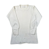 An off-white ribbed long-sleeve crewneck thermal shirt laid flat on a light gray background.